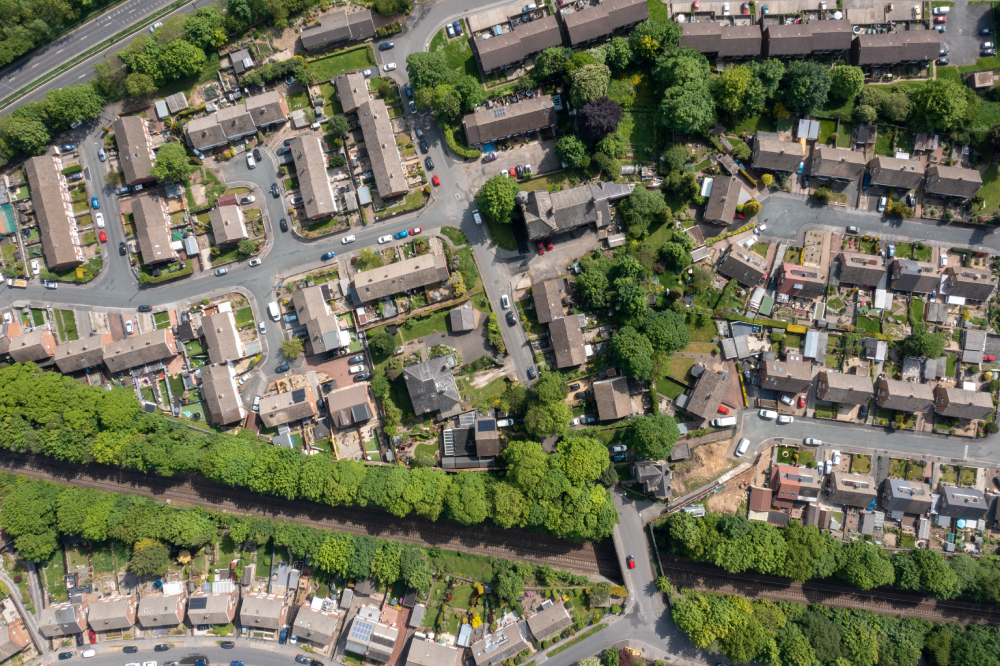Top-down photograph of residential streets with trees and greenery